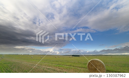 A vast, open field sprawls beneath stunning skies that evoke deep wonder and awe A vast, open field sprawls beneath stunning skies that evoke deep wonder and awe 130387962