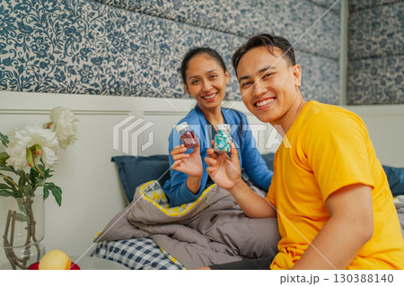 Joyful Moments: A Mother and Son Sharing Treats in a Cozy Home Setting Joyful Moments: A Mother and Son Sharing Treats in a Cozy Home Setting 130388140