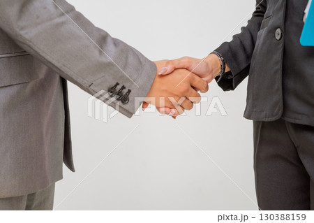 Business Professionals Engaging in a Formal Handshake to Demonstrate Trust and Respect 130388159