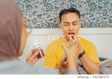 A Couple Sharing Health Supplements Together in Their Comfortable, Cozy Home A Couple Sharing Health Supplements Together in Their Comfortable, Cozy Home 130388175