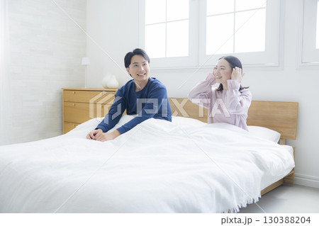 ベッドでリラックスする夫婦 130388204
