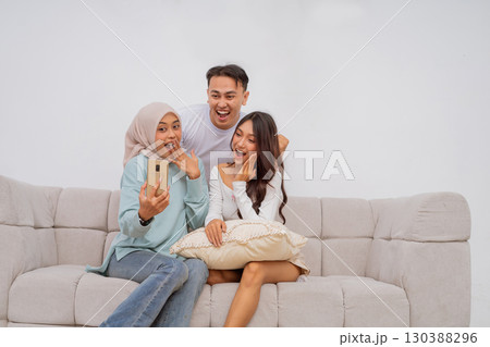 Capture a Fun Group Selfie Moment on the Couch with Friends All Together Here Capture a Fun Group Selfie Moment on the Couch with Friends All Together Here 130388296