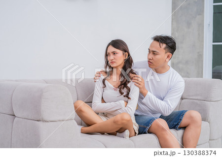 A Couple in Conflict Engaging in an Emotional Conversation While Seated on a Sofa A Couple in Conflict Engaging in an Emotional Conversation While Seated on a Sofa 130388374
