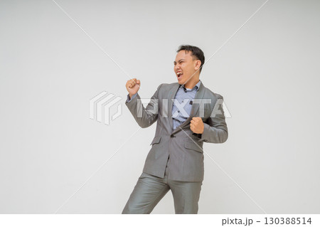 An Energetic Businessman Joyfully Celebrating His Success While Wearing a Stylish Suit An Energetic Businessman Joyfully Celebrating His Success While Wearing a Stylish Suit 130388514