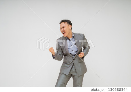 A Joyful Businessman Exuberantly Celebrating His Success While Wearing a Stylish Suit A Joyful Businessman Exuberantly Celebrating His Success While Wearing a Stylish Suit 130388544