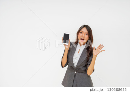 An Excited Businesswoman Holding a Smartphone is Dressed in Stylish Attire Today An Excited Businesswoman Holding a Smartphone is Dressed in Stylish Attire Today 130388633