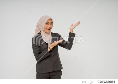 A Cheerful Businesswoman Presenting with a Bright Smile in Professional Attire A Cheerful Businesswoman Presenting with a Bright Smile in Professional Attire 130388664