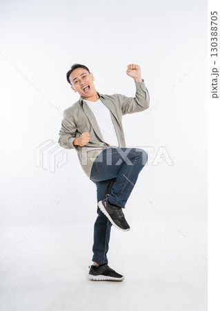 A Vibrant and Energetic Young Man Joyfully Dancing with Great Excitement in a Studio A Vibrant and Energetic Young Man Joyfully Dancing with Great Excitement in a Studio 130388705