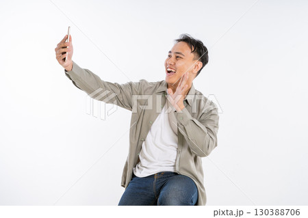 A Joyful Young Man Capturing a Selfie with a Relaxed and Positive Vibe A Joyful Young Man Capturing a Selfie with a Relaxed and Positive Vibe 130388706