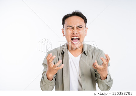 Furious Young Man Expressing Anger and Frustration on White Background Furious Young Man Expressing Anger and Frustration on White Background 130388793