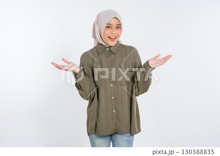 A Cheerful Young Woman Dressed in Casual Outfit with Open Hands Gesture Sign 130388835