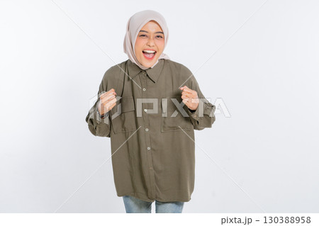 Joyful Young Woman Celebrating Her Success While Wearing a Casual Outfit 130388958