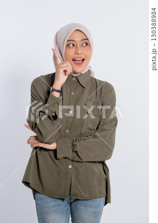 A Young Woman Sporting a Casual Outfit while Displaying a Delightful Gesture 130388984