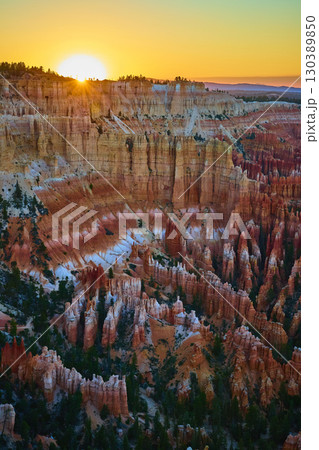 Bryce Canyon National Park Hoodoos at Sunset with Golden Sunburst and Layered Cliffs 130389850