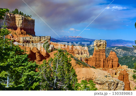 Bryce Canyon Hoodoos and Cliffs with Pine Trees under Vibrant Blue Sky Bryce Canyon Hoodoos and Cliffs with Pine Trees under Vibrant Blue Sky 130389863
