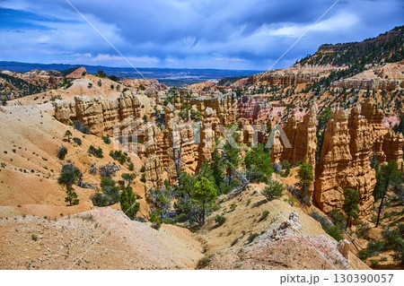 Bryce Canyon Hoodoos Dramatic Rock Formations and Pine Trees Under Blue Sky 130390057