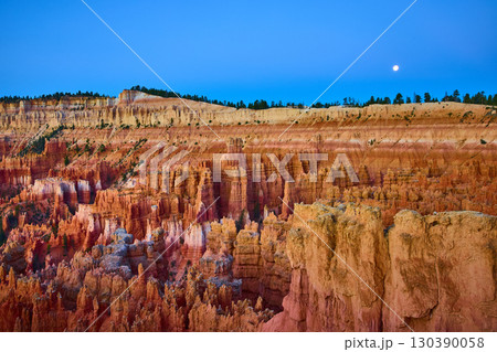 Bryce Canyon Hoodoos at Sunset with Moon and Dramatic Golden Hour Sky Bryce Canyon Hoodoos at Sunset with Moon and Dramatic Golden Hour Sky 130390058