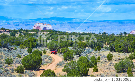 Aerial Red SUV in Motion on Desert Road with Vermilion Cliffs in Background Aerial Red SUV in Motion on Desert Road with Vermilion Cliffs in Background 130390063