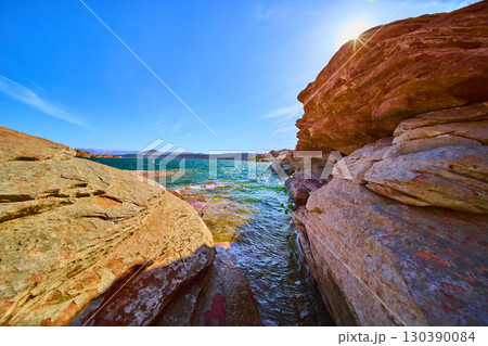 Red Rock Formations and Blue Lake with Sunburst Low Perspective Sand Hollow Utah Red Rock Formations and Blue Lake with Sunburst Low Perspective Sand Hollow Utah 130390084