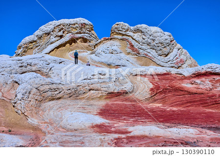 White Pocket Sandstone Formations with Hikers and Blue Sky Arizona Low Angle White Pocket Sandstone Formations with Hikers and Blue Sky Arizona Low Angle 130390110
