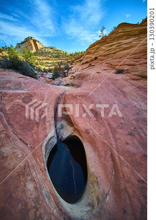 Sandstone Pothole with Water and Desert Mesa Motion Low Angle Perspective Sandstone Pothole with Water and Desert Mesa Motion Low Angle Perspective 130390201