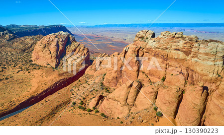 Aerial Vermilion Cliffs and Marble Canyon Sunlit Sandstone Formations Fly Over 130390223
