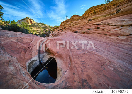 Sandstone Pools and Desert Cliffs with Mesa Reflection Ground Level Perspective 130390227