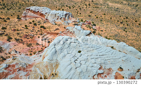 Aerial Fly Over White Pocket Rock Formations and Colorful Desert Bands 130390272