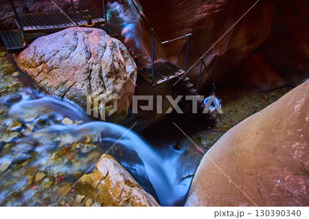 Kanarra Falls Waterfall Motion Blur with Hikers and Staircase Elevated View Kanarra Falls Waterfall Motion Blur with Hikers and Staircase Elevated View 130390340