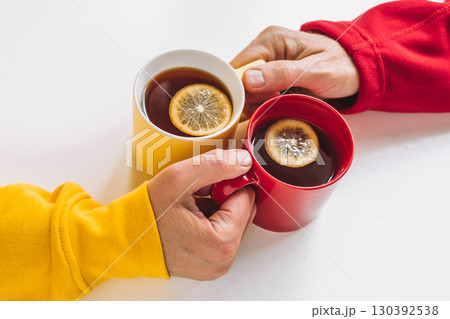 friends share warm cups lemon tea while enjoying cozy afternoon at home during fall season. closeup. 130392538