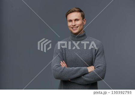 smiling young caucasian man with grey sweater crossed arms digital detox concept isolated on grey background studio portrait smiling young caucasian man with grey sweater crossed arms digital detox concept isolated on grey background studio portrait 130392793