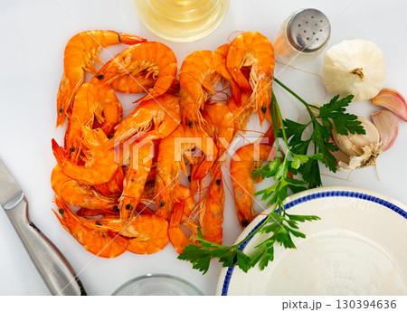 Defrosted red prawns on table with garlic, parsley, salt and wine vinegar 130394636