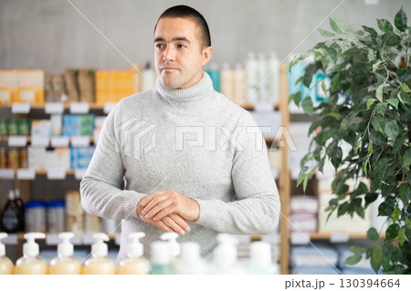Man in drugstore looking for something Man in drugstore looking for something 130394664