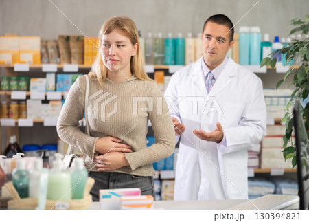 Woman with spasms on the background of a pharmacist Woman with spasms on the background of a pharmacist 130394821