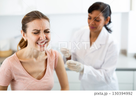 Woman doctor vaccinating patient 130394992