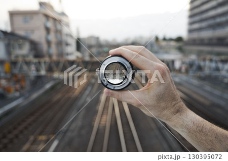 Urban railway bridge viewed through camera lens 130395072