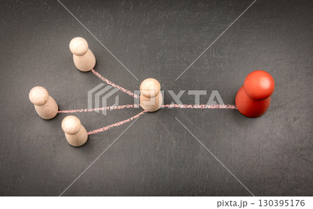 Leader figure connected to team members with chalk lines symbolizing communication and authority Leader figure connected to team members with chalk lines symbolizing communication and authority 130395176