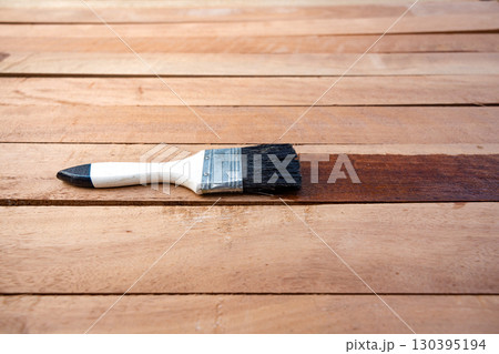 Paint brush and wood material in construction work. Paint brush and wood material in construction work. 130395194