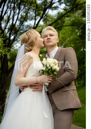 Romantic outdoor wedding photography at a lush green park in springtime 130395283