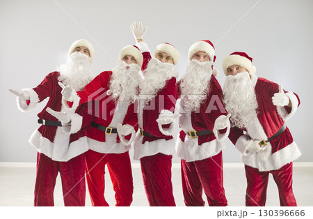 People in Santa Claus costumes celebrating New Year and Christmas holidays People in Santa Claus costumes celebrating New Year and Christmas holidays 130396666