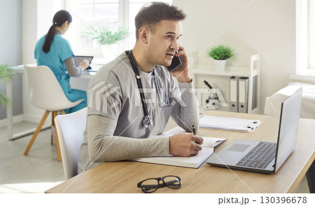 Male Doctor Working With Laptop In Hospital Office Male Doctor Working With Laptop In Hospital Office 130396678