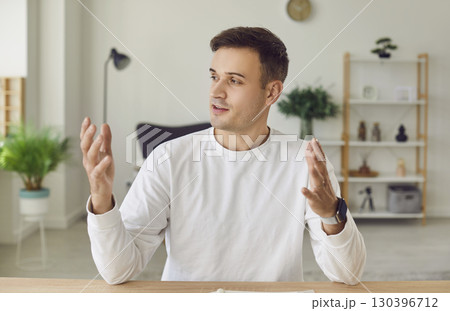 Portrait of man speaking and gesticulating during business webinar conference call 130396712