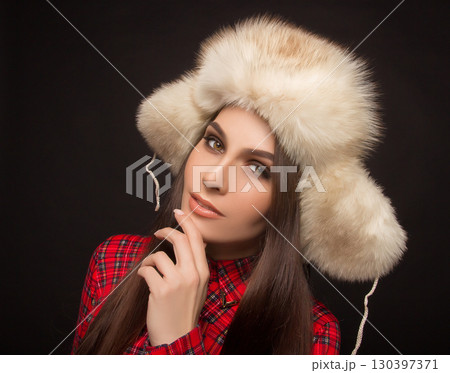 portrait of a beautiful girl in shirt and fur hat portrait of a beautiful girl in shirt and fur hat 130397371