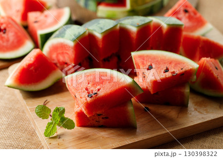 Slices of fresh watermelon on rustic wooden background. Slices of fresh watermelon on rustic wooden background. 130398322