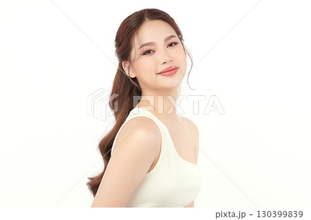 A beautiful young Asian woman with clean, fresh skin against a white background. Skincare, facial treatment, cosmetology, beauty, and spa. An elegant portrait of an Asian woman. 130399839