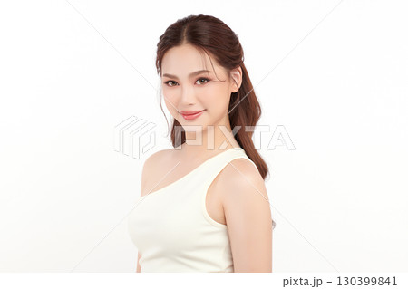 A beautiful young Asian woman with clean, fresh skin against a white background. Skincare, facial treatment, cosmetology, beauty, and spa. An elegant portrait of an Asian woman. 130399841