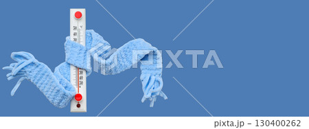A thermometer wrapped in a cozy blue scarf indicates cold weather A thermometer wrapped in a cozy blue scarf indicates cold weather 130400262
