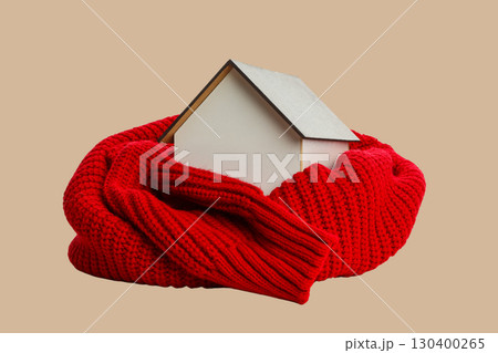 Mini house wrapped in a cozy red scarf for warmth 130400265