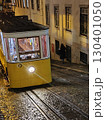 Vintage yellow tram navigating cobblestone streets at night in Lisbon, showcasing urban charm and historic transportation in a vibrant city atmosphere. Elevador da Gloria, Gloria funicular, Lisboa 130401050