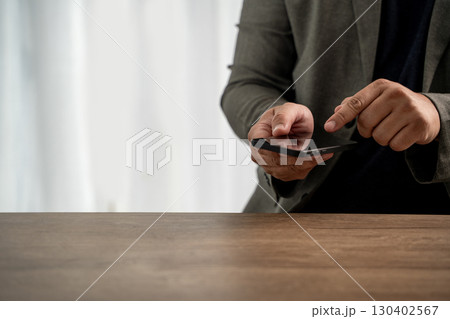 Business man checking phone with finger tap 130402567